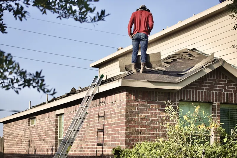 Professional roofer working on a residential roof in Fort Hill